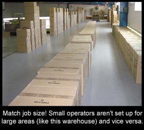 Resin flooring over a large warehouse floor with boxes stacked on it.