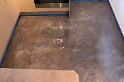 Kitchen in the residential apartment with graphite marble metallic epoxy floor installed.