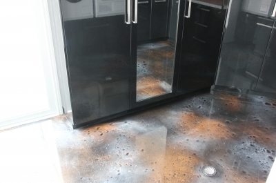 The cosmic-looking metallic epoxy floor pictured with one of the closets in the laundry.