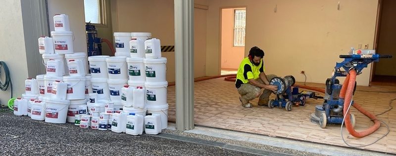 An installer prepares for work with all of the required product for the project lined up outside the garage door.